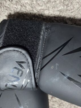 Sleek Matte Black Boxing Gloves with Subtle Logo